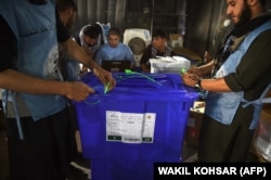 Independent Election Commission workers seal ballot boxes as they prepare for the upcoming presidential election at a warehouse in Kabul on September 16.