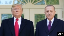 U.S. President Donald Trump greets Turkey's President Recep Tayyip Erdogan (L) upon arrival outside the White House in Washington, DC on November 13, 2019. 