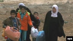 A Palestinian family leaves its house in Gaza City on January 16.