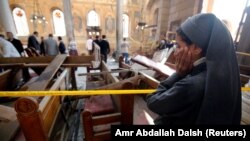 A nun cries as she stands at the scene inside Cairo's Coptic cathedral following a deadly bomb attack on December 11.