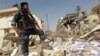 A policeman inspects damages following a June 4 bomb attack on the Shi'ite endowment headquarters in central Baghdad.