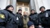 Ukraine -- Newly elected speaker of parliament Oleksander Turchynov (C) poses for a picture with a group of anti-government protesters outside the Ukrainian parliament building in Kiev February 22, 2014. Protesters seized the Kiev office of President Vikt