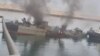 Konarak naval vessel still burning after being towed to port. May 11, 2020.