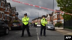 British police officers secure a cordon in a residential street in northwest London on April 28.