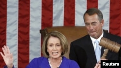 U.S. -- Outgoing House Speaker Nancy Pelosi yields the podium to incoming House Speaker John Boehner as he wields the speaker's gavel for the first time after being elected Speaker, Washington, DC, 05Jan2011