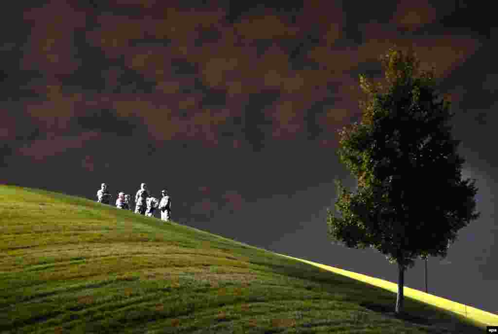 U.S. National Guard officers keep watch from a hill in Ferguson, Missouri, as demonstrators protest on August 21 against the police shooting of Michael Brown, an unarmed 18-year-old black man. Violent protests erupted in the wake of Brown&#39;s death in August and again in November, when the police officer responsible was acquitted. (Larry W. Smith, epa)