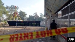 A Pakistani police commando stands guard at the cordoned-off site of a suicide bombing in Lahore the capital on Punjab on March 27.