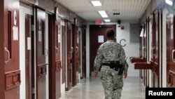 A guard walks through a cell block used to house detainees at a U.S. Naval Base in Guantanamo Bay, Cuba. (file photo)