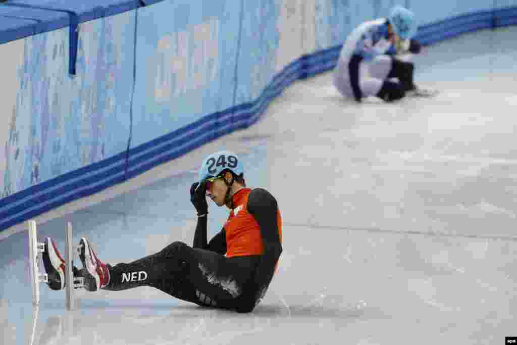 Vladimir Grigorev (rear) of Russia and Freek van der Wart of the Netherlands after both crashed out during men&#39;s 500-meter quarterfinals of the short-track event in the Iceberg Skating Palace.