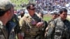 A U.S. officer speaks with a fighters from the Kurdish YPG at the site of Turkish air strikes near the northeastern Syrian Kurdish town of Derik in April.