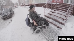 Andrei Vinogradov, a Russian disability activist in Tomsk, shows a building without wheelchair access. 