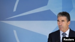 NATO Secretary-General Anders Fogh Rasmussen briefs the media after a meeting of the North Atlantic Council in Brussels on June 26.