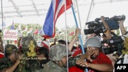 Protesters loyal to ex-premier Thaksin storm the venue of the ASEAN summit on April 11