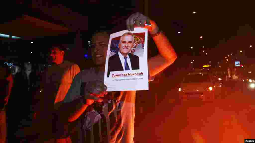 A supporter of the nationalist Serbian Progressive Party (SNS) celebrates Tomislav Nikolic's victory in a presidential election in Belgrade on May 20. (Reuters/Djorde Kojadinovic) 