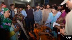 Relatives of injured victims gather outside the hospital in Lahore, Pakistan, after a deadly blast hit a public park on Easter Sunday, killing dozens and wounding hundreds more.