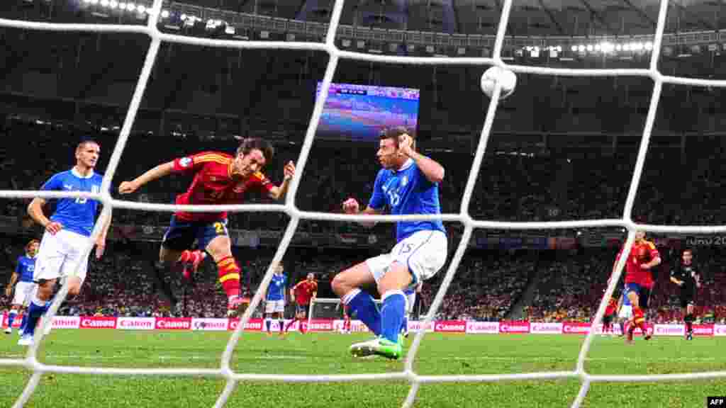 David Silva heads the ball to score Spain's first goal in a 4-0 victory over Italy in the Euro 2012 final at the Olympic Stadium in Kyiv on July 1. In winning Euro 2012, Spain became the first nation to win three major international tournaments in succession. (AFP/Giuseppe Cacace)