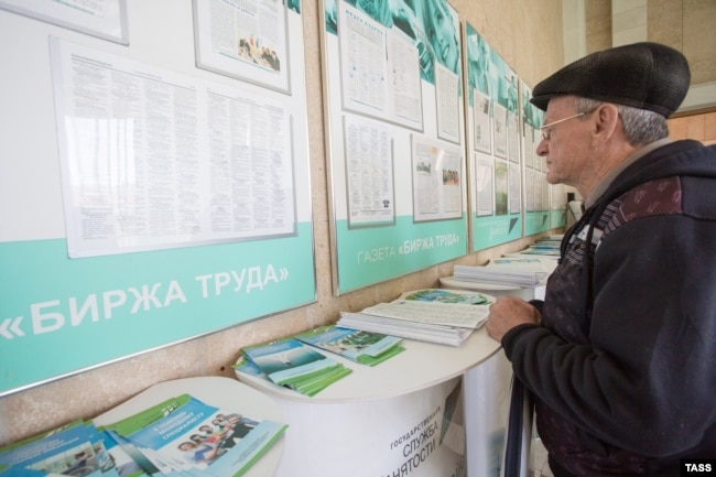 A man checks lists of vacancies at a Russian job center in Omsk. (file photo)