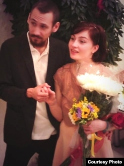 Aleksandra Dukhanina and her husband, Artyom Naumov, during their wedding at a marriage-registry office in Moscow.