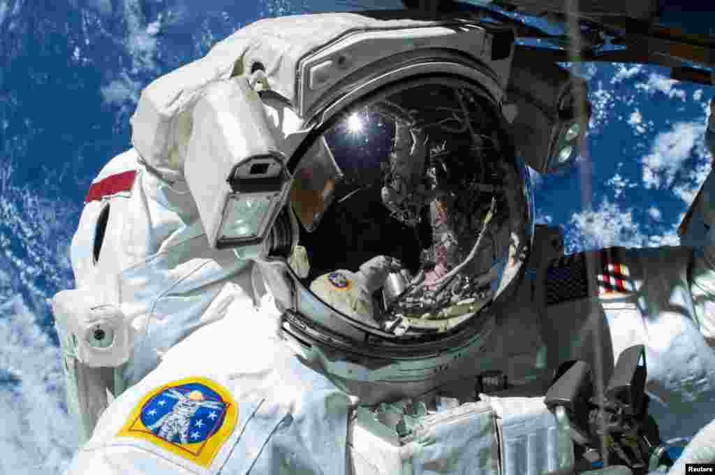 NASA astronaut Barry "Butch" Wilmore is caught on camera as the Earth's surface passes by in the background on the International Space Station. (Reuters)