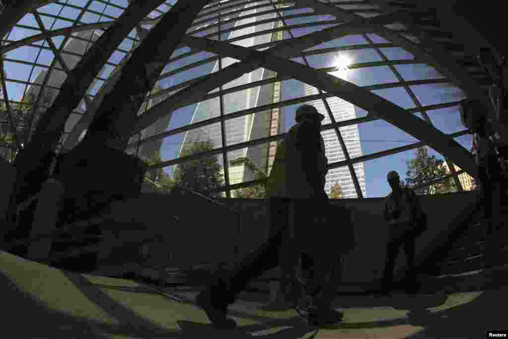 A construction worker walks past two steel "tridents" recovered from the World Trade Center site after September 11, 2001, in the entry pavilion area of the new museum.