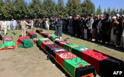 Funeral services were held for 12 Afghan schoolgirls who died trying to flee their school during the quake.