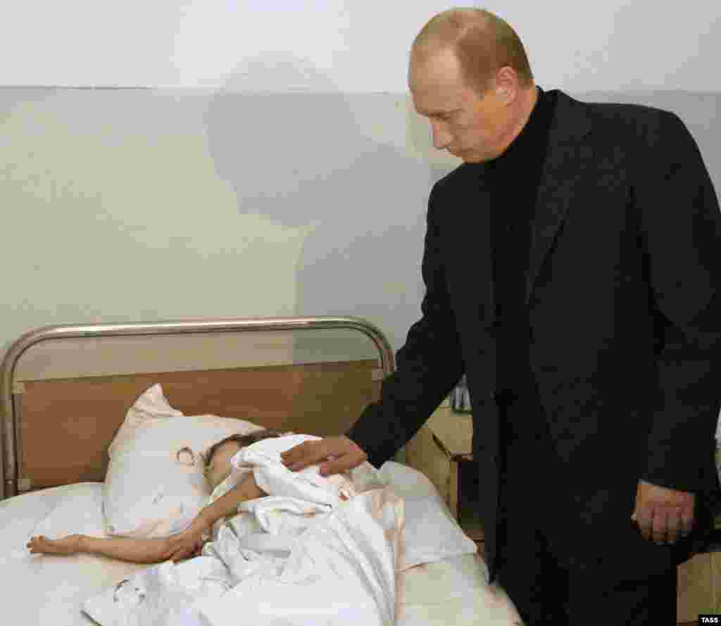 Russian President Vladimir Putin visiting victims of the hostage taking in Beslan on September 4, 2004 (TASS) - "We are absolutely convinced that they want to forget Beslan," says Ella Kesayeva, who lost two nephews during the tragedy. "The authorities don't want to hear or know anything about Beslan." 