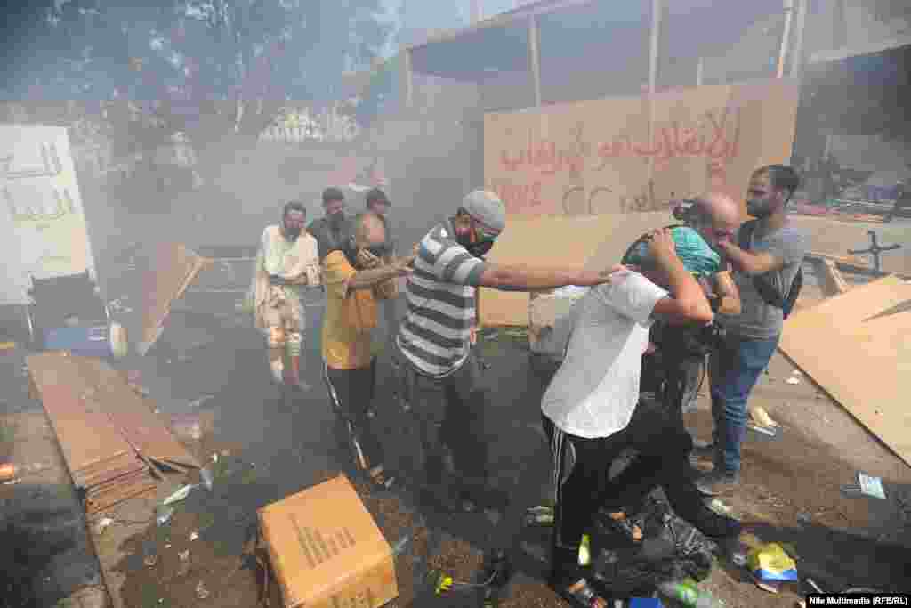 Police lead away supporters of deposed President Muhammad Morsi on Nahda Square.