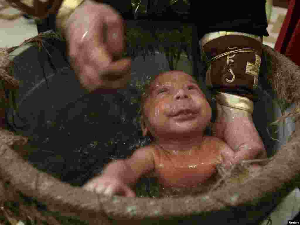 A baby is baptized during a mass baptism ceremony in Tbilisi, Georgia, on March 3. Photo by David Mdzinarishvili for Reuters