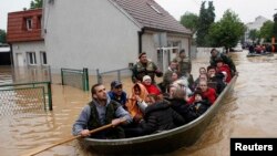 Serbian soldiers evacuate people in a boat in the flooded town of Obrenovac, southwest of Belgrade, on May 17.