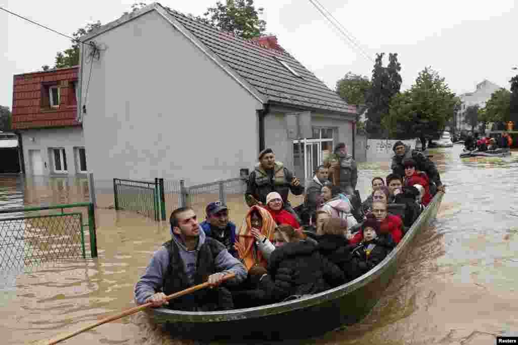 Serbian soldiers evacuate people in a boat in the flooded town of Obrenovac, southwest of Belgrade, on May 17. (Reuters/Marko Djurica)