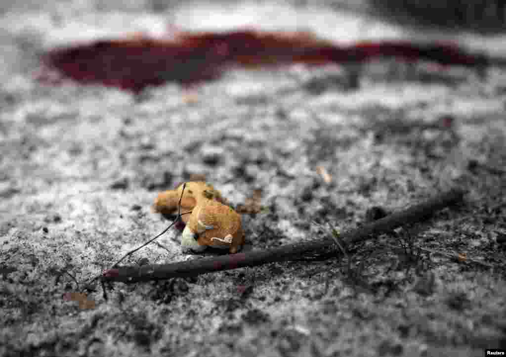 A teddy bear lies near a puddle of blood at the site of recent shelling in a residential area of the eastern Ukrainian town of Kramatorsk on February 10. (Reuters/Gleb Garanich)