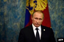 Russian President Vladimir Putin holds a press conference on November 30 in Paris on the sidelines of the climate change summit.