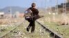 A Turkish boy walks along railroad tracks disused since the closure of the Turkish-Armenian border. The new agreement foresees the border reopening.