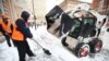 Utility workers shovel snow on Suvorovsky Prospekt Street in St. Petersburg on January 10.