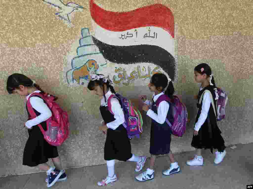 Iraqi students walk to class on the first day of the new semester in Baghdad on October 22. (AFP/Ahmad Al-Rubaye)