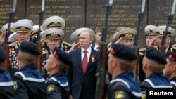 Ukraine - Russian President Vladimir Putin (C) stands with military personnel during a ceremony marking Victory Day, in Sevastopol, Crimea, May 9, 2014