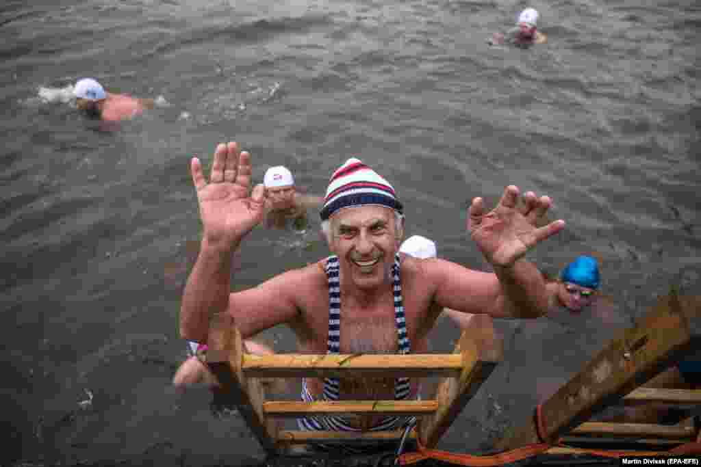 A swimmer climbs out of Prague&#39;s Vltava River during a traditional winter swimming event on December 26. (epa-EFE/Martin Divisek)