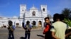 Sri Lankans gather outside St. Anthony's Shrine a day after a series of blasts in Colombo. Hundreds were killed in the April 21 attacks across the island nation.