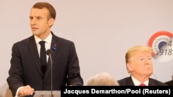 France, Paris, French President Emmanuel Macron delivers a speech as U.S. President Donald Trump looks on, before a lunch at the Elysee Palace, during commemorations for Armistice Day 11nov2018