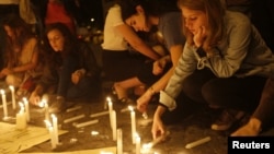 Protesters light candles in memory of victims of the recent violent antigovernment protests in Turkey in Istanbul's Taksim Square on June 14.