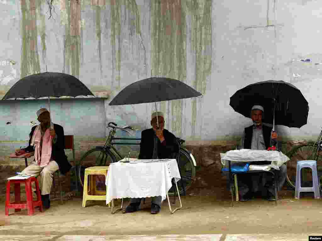 Afghan letter writers wait for customers in Kabul. Some two-thirds of Afghanistan's population is illiterate, and some rely on professional letter writers to communicate with relatives. Photo by Omar Sobhani for Reuters