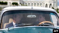 Turkmen President Gurbanguly Berdymukhammedov (right) and Russian Prime Minister Dmitry Medvedev ride in a GAZ-21 Volga car during a meeting in Ashgabat on May 31.