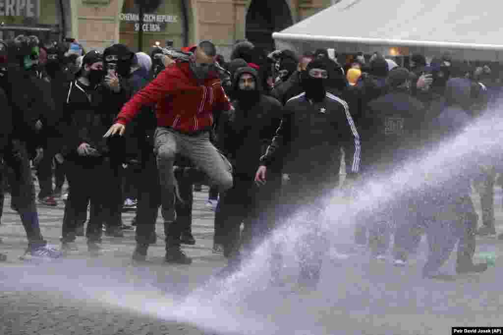 Czech police used tear gas and a water cannon to disperse crowd of hundreds of violent protesters who attacked them after a rally in Prague against the government&#39;s restrictive measures imposed to slow the spread of the coronavirus infections.