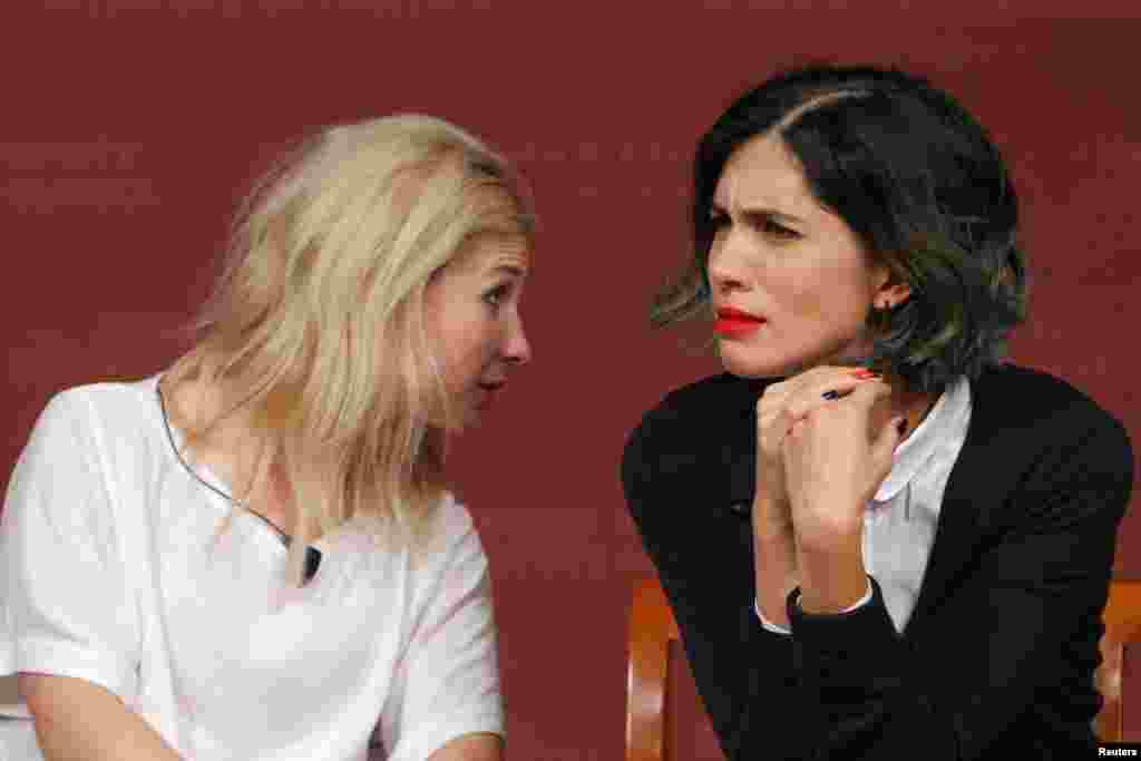 Maria Alyokhina (left) and Nadezhda Tolokonnikova, members of the punk protest band Pussy Riot, listen to a question from the audience during a forum at the Kennedy School of Government at Harvard University in Cambridge, Massachusetts. (Reuters/Brian Snyder) 