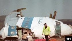 A policeman walking next to the wreckage of the Pan Am 747 Boeing cockpit a day after the plane exploded over Lockerbie, Scotland in December 1988.