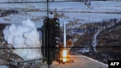 The rocket Unha-3, carrying the satellite Kwangmyongsong-3, is monitored on a large screen at a satellite control center in North Korea on December 12.