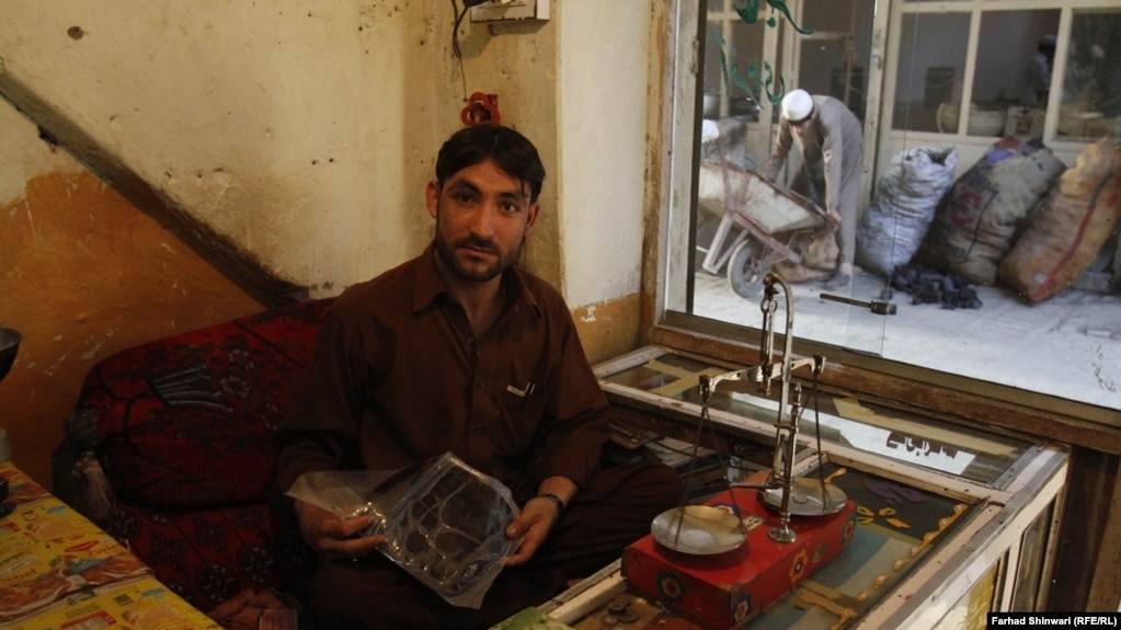 A Pakistani hashish seller shows off his black gold in the country's northern tribal region. 