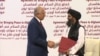 FILE: U.S. Special Representative for Afghanistan Reconciliation Zalmay Khalilzad and Taliban leader Mullah Baradar Abdul-Ghani shaking hands after signing an agreement on February 29.