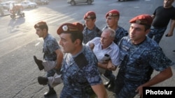 Armenia - Riot police detain a man at a street section in Yerevan close to a police station seized by opposition gunmen, 27Jul2016.