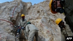 FILE: Afghan miners work at a gold mine in northern Afghanistan.